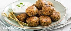 a white plate topped with meatballs and dip