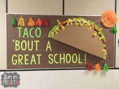 a bulletin board with taco'bout a great school written on it and decorations