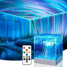 a remote control sitting next to an ice cube in front of a room with blue lights