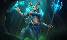 an image of a woman holding a blue staff in the woods with her hands up