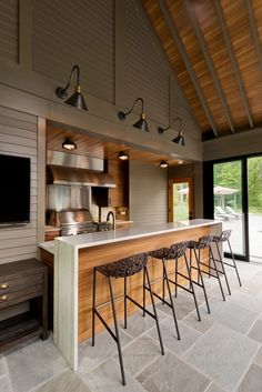 a kitchen with an island and several stools next to the counter top that is built into the wall