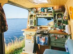 the inside of a camper with an open door and lots of clutter on it