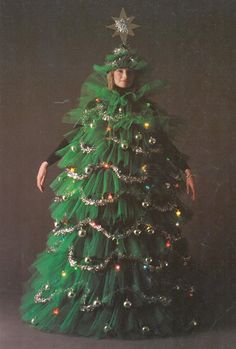 a woman in a green christmas tree costume