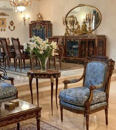 a living room filled with furniture and a chandelier