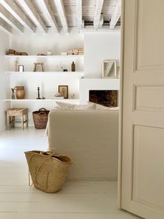 a living room filled with furniture and white walls