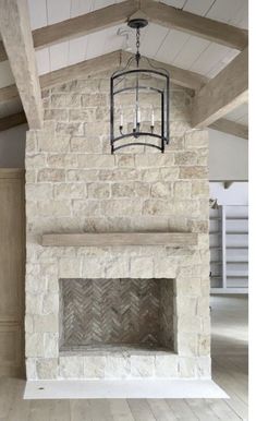 a fireplace with a light fixture hanging from it's side