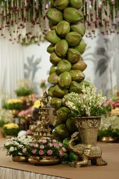 there are many different types of flowers and fruits on the table in front of each other