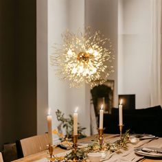 a dining room table is set with candles and place settings