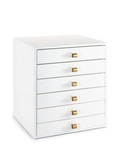 a white drawer with five drawers and gold handles