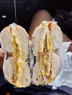 the sandwich is cut in half and ready to be eaten with cheese on it's buns