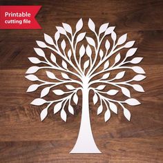 a paper cutout of a tree on a wooden surface with the words printable cutting file