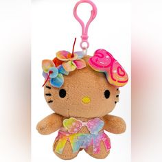 a hello kitty keychain with a pink bow and flower on it's head