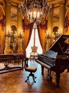 a grand piano sits in front of a chandelier