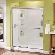 a bathroom with green walls and white fixtures