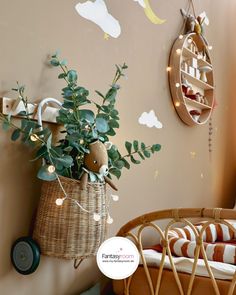 there is a basket with plants in it on the wall next to a baby crib