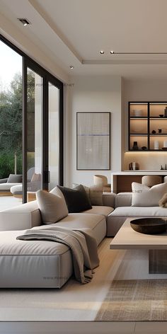 a modern living room with white furniture and large windows looking out onto the outdoors area