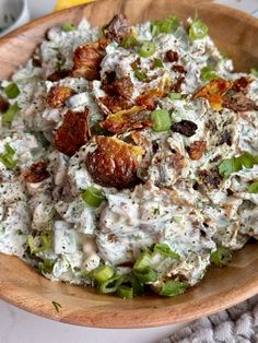 a wooden bowl filled with lots of food