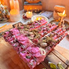 a table topped with lots of different types of candy and candles on top of it