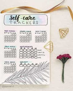 a planner with stickers and flowers next to it on a white surface, which says self care trackerrs