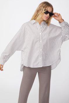 Style Information:Striped button front shirt with dolman sleeves. A great classic shirt that's easy to style at the office or out and about. The vertical stripes slim down the body and fits relaxed. Dolman Shirt, Linen Shop, Jacket Brands, Romper With Skirt, Out And About, Button Front Shirt, How To Slim Down, Vertical Stripes, Dress Romper