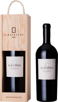 a bottle of gaudio classico wine in a wooden box next to it