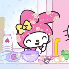 hello kitty is eating donuts in front of a pink wall with other items on it