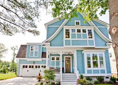 a blue house with white trim and windows