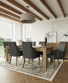 a dining room table surrounded by chairs and rug