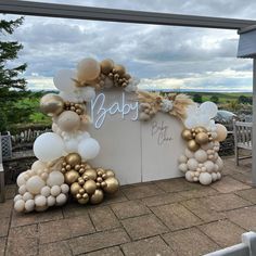 a baby shower sign with balloons and streamers