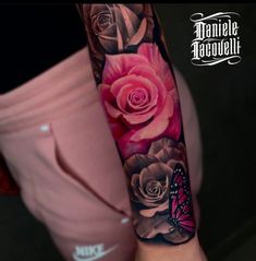 a woman's arm with pink roses and a butterfly on the left side of her arm