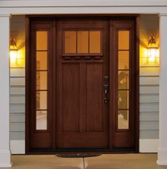 the front door to a house with two lights on