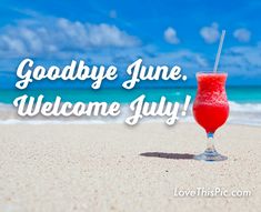 a drink sitting on top of a sandy beach next to the ocean with words goodbye june welcome july