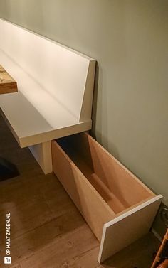 a bench that has been built into the side of a wall with drawers underneath it