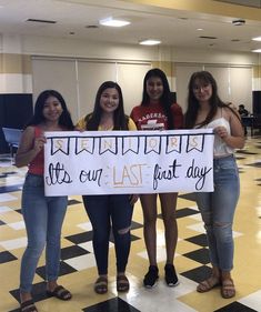 four girls holding a sign that says let's our last day