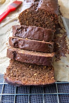 a loaf of chocolate banana bread sitting on top of a cooling rack