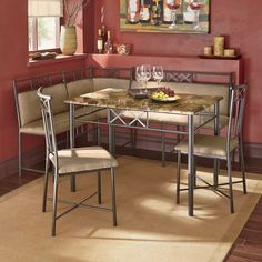 a dining room table with two chairs next to it and a painting on the wall