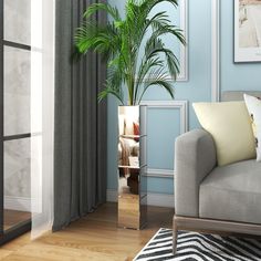 a living room with a couch and a potted plant