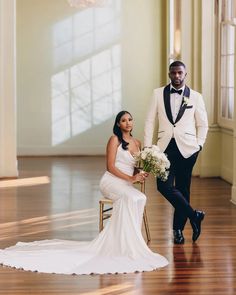 a bride and groom pose for a wedding photo in the grand ballroom at their wedding