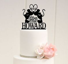 there is a wedding cake topper on this white cake