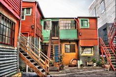 an alleyway with multiple colored buildings and stairs