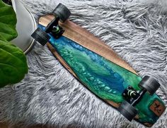 a skateboard is laying on top of a fur rug next to a potted plant