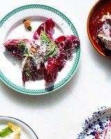 three plates with different foods on them sitting on a table top next to each other