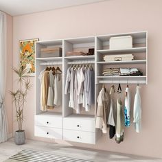 a white closet filled with lots of clothes next to a window and potted plant