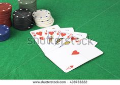 playing cards and poker chips on a green table