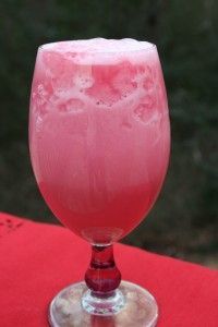 a pink drink sitting on top of a red table