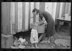 an old black and white photo of two women with a child