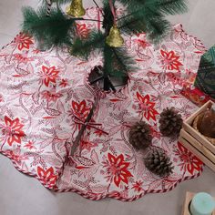 a christmas tree skirt with pine cones on it