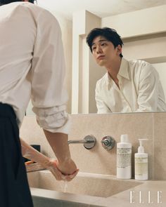 a person standing in front of a bathroom sink