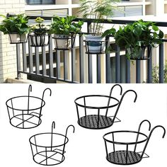 four potted plants are hanging on the outside of a balcony rail and in front of an iron planter