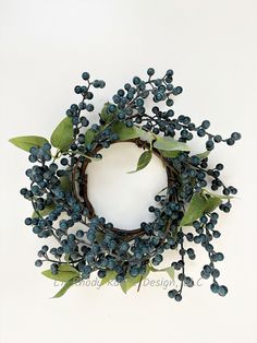 This Powdered  Blueberry with Greenery Artificial Candle Ring is the perfect way to add charm to any home. All berries and greenery are attached to hand-wrapped twig stems. The ring is very pliable and easily bends. Measures: 4 1/2" Inside Diameter, Width varies upon shaping. Candle rings are made using synthetic materials, such as polyester material or plastic, and are well-designed and constructed to be life-like in appearance. This item will need to be re-shaped when removed from the box to allow it to reach its fullest size. Berries are not waterproof and is recommended for indoor use. Choking hazard - small parts. Not suitable for children under 3 years of age. Color may vary due to editing and monitor resolution. Color may vary due to editing and monitor resolution. Need the matching Diy Candle Ring, Candle Rings Diy, Artificial Candles, Floral Candle Rings, Farmhouse Candle, Farmhouse Candles, Mini Candle, Holiday Candle, Candle Ring